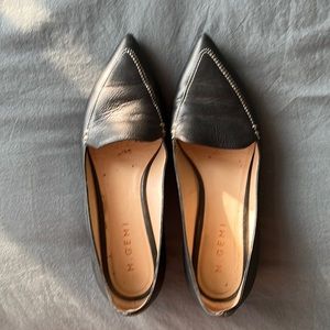 Black pointy toe flats with white stitching detail